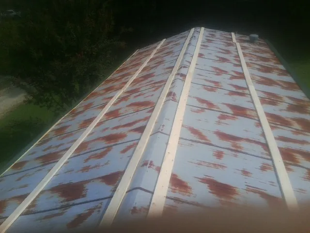 Rusted metal roof panels with new wood purlins before replacement — Storm Damage Roof Repair in Palos Park by Roofing Brothers